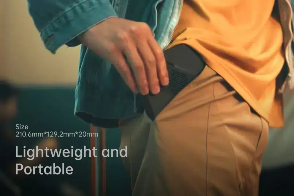 gempages_522757109238989843-ded664d6-df37-43e1-9237-016fcf23d2c1 - DROIX EU Close-up of the ONEXPLAYER X1 Mini being slipped into a pocket, showcasing its compact dimensions (210.6mm x 129.2mm x 20mm) and lightweight design.