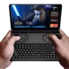 GPD WIN Mini 2024: Powerful handheld gaming PC with 7" FHD 120Hz VRR display. Features AMD Ryzen 7 8840U, 32GB RAM, 1TB NVMe storage. Clamshell design combines full QWERTY keyboard with gaming controls, including dual joysticks and buttons. Compact form factor held comfortably in hands. Screen displays game character with glowing sword, showcasing vibrant graphics. Specs visible: 7" screen, 120Hz VRR, Ryzen 7 8840U, 32GB RAM, 1TB storage. "HANDHELD PC - CLAMSHELL" emphasized. AMD Ryzen and Radeon logos present. Device offers portable gaming and productivity in one, bridging gap between handheld console and mini laptop.