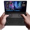 Hands holding the GPD Win Mini 2025, a clamshell handheld PC with a 7-inch 120Hz VRR display, powered by AMD Ryzen AI 9 HX 365/370 or Ryzen 7 8840U processors. Featuring up to 64GB RAM and 4TB NVMe storage, it is optimized for gaming and productivity with Hall Effect joysticks, a full QWERTY keyboard, and stunning cyberpunk-themed visuals on the screen.