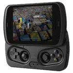 A black RG SLIDE handheld gaming device is shown with its screen slid up to reveal the game controls. The screen displays a game selection menu featuring "MAME (1997)" and images of arcade cabinets against a background of classic game cartridges. The device has a D-pad and analog stick on the left, and ABXY buttons and another analog stick on the right.