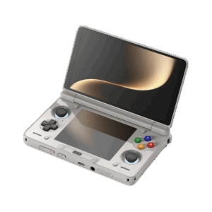 An angled, open view of a light grey AYN Thor handheld gaming console with a clamshell design, against a dark, featureless background. The top screen is open, displaying a soft golden abstract image. The bottom half of the device shows the controls, including a black D-pad, black analog sticks, and face buttons in red, blue, green, and yellow, resembling the classic "rainbow" controller aesthetic. Both the top and bottom screens are reflective, mirroring the golden light.