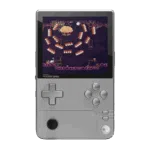 AYANEO-POCKET-DMG-SILVER-LISTING-DONE-01 A front-on view of the AYANEO Pocket DMG handheld gaming console in a silver/grey color, set against a black background. The console has a vertical, Game Boy-inspired form factor with a large screen displaying a retro-style pixel art game featuring a cloud-like boss and orange projectiles. The controls include a prominent grey D-pad on the left, grey A, B, X, Y face buttons on the right, and a black analog stick positioned below the D-pad. The AYANEO POCKET DMG logo is visible below the screen.