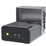 A product shot showing two identical compact mini PCs on a solid black background. One unit sits horizontally in the foreground, displaying its front panel with a glowing green power button, three USB-A ports, a Type-C port, and a headphone jack. The second unit is placed vertically directly behind it, showcasing its sleek gray side panel with the "GMKtec" logo and a view of the rear I/O connectivity ports.